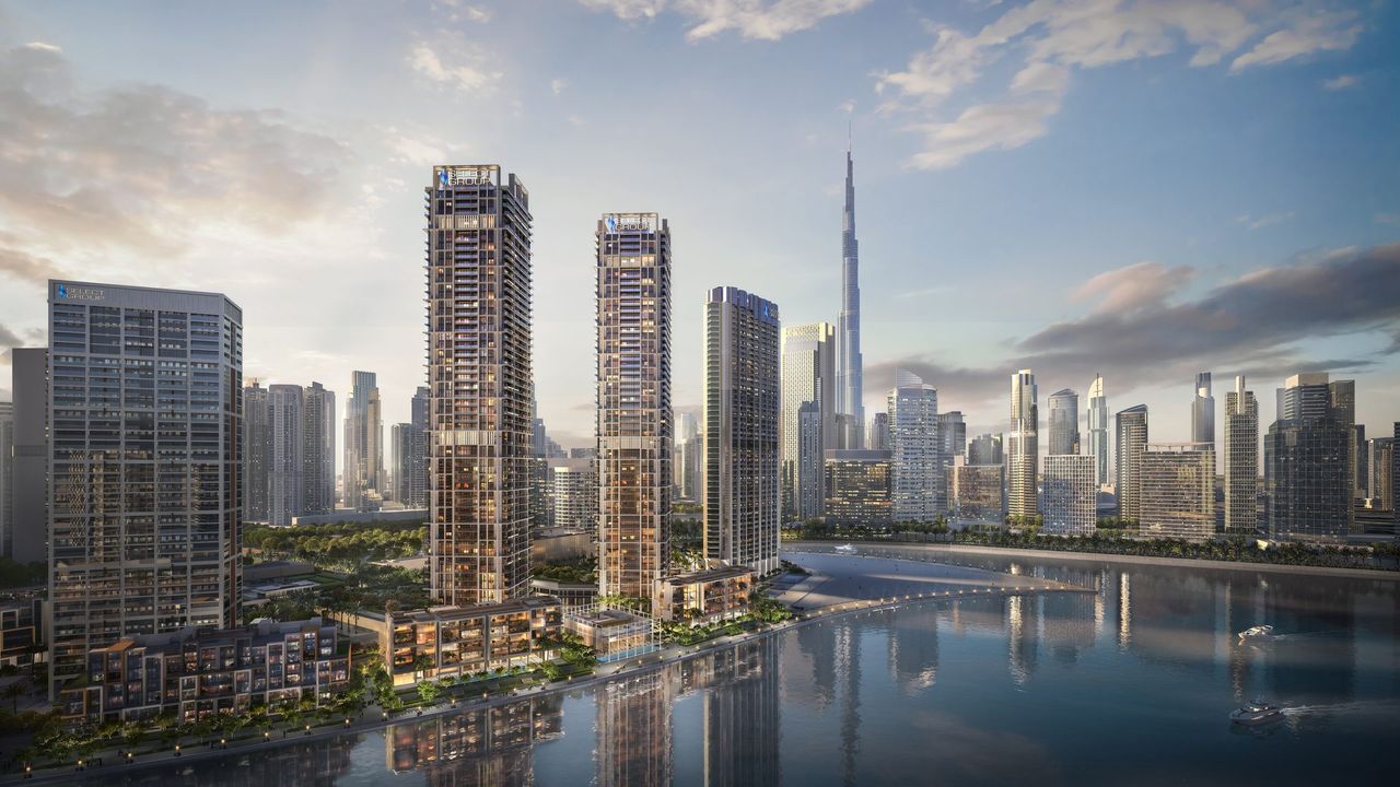 Башни Peninsula в Business Bay у воды, за ними Бурдж-Халифа и Downtown